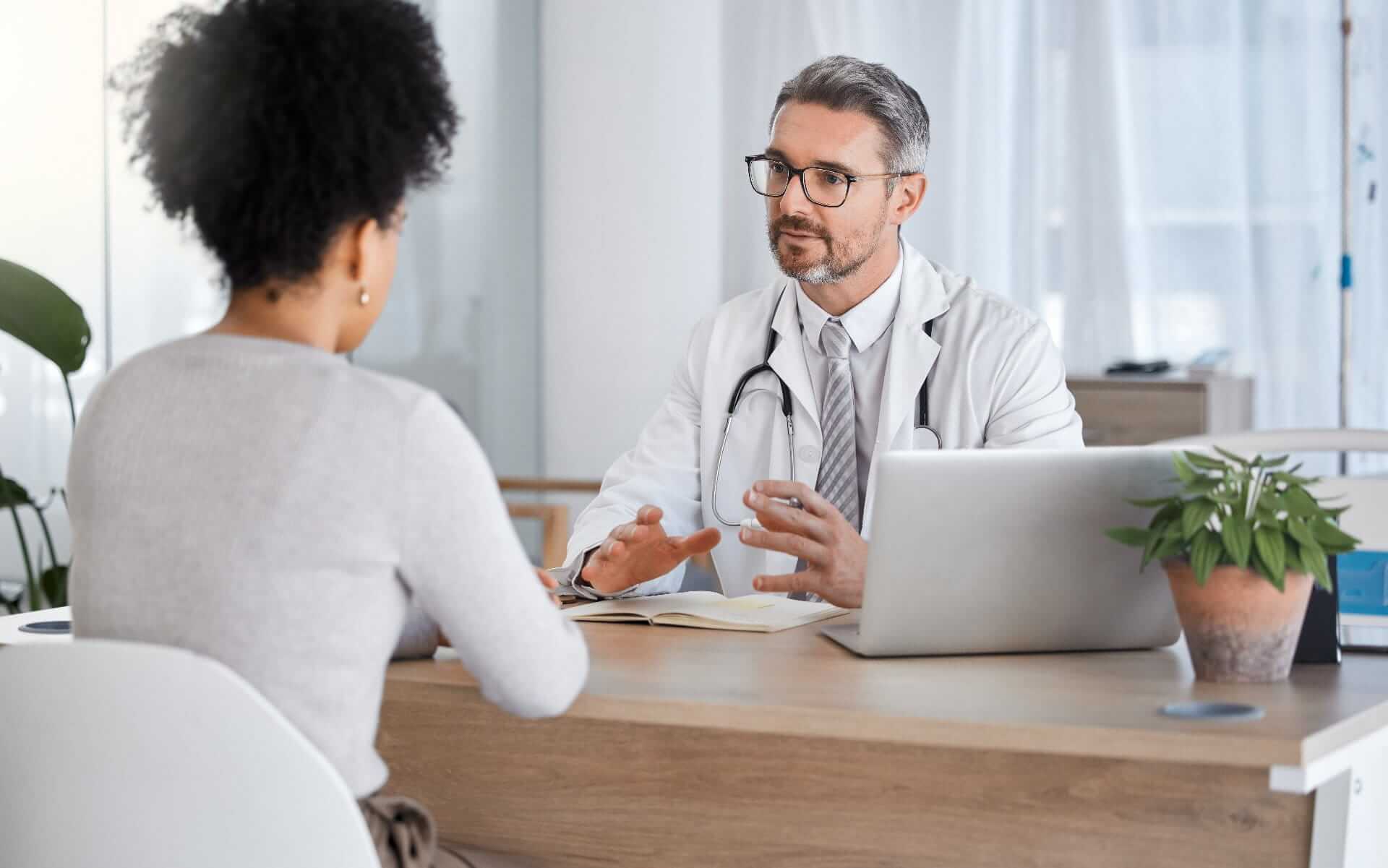patient discussing private medical insurance with doctor
